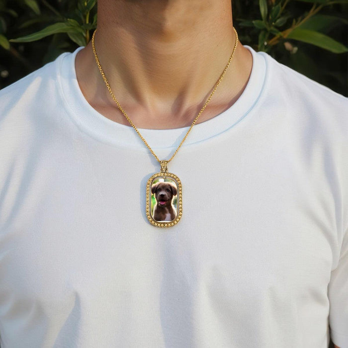 Gold photo pendant necklace worn on a white shirt with oval dog portrait charm