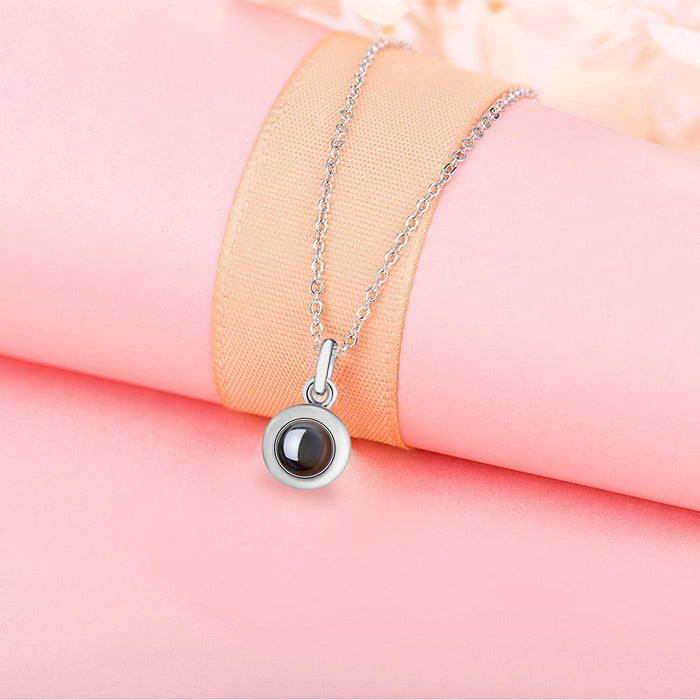 Rose-toned round projection pendant necklace with chain and clear window