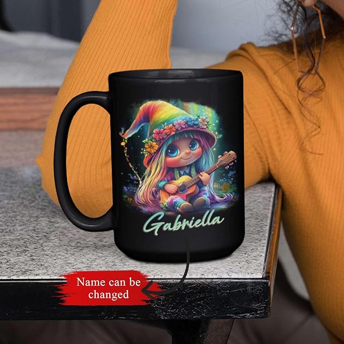 Black mug featuring rainbow-hat guitar girl art and name Gabriella