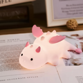 Pink baby dragon night light with a soft silicone body and glowing face details