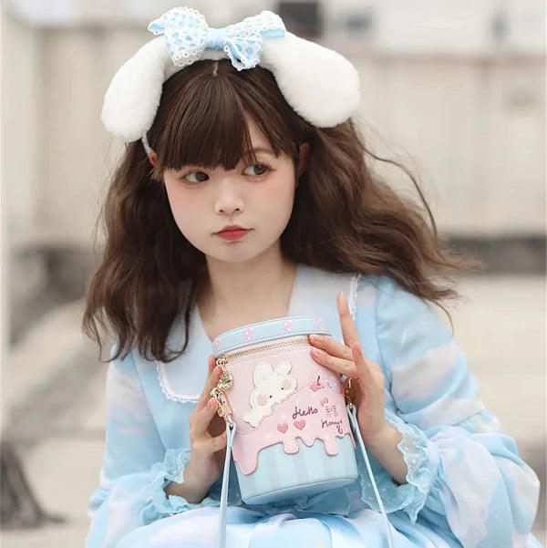 Pink bunny bucket bag with light blue bottom, front bunny applique and script hearts, zip top