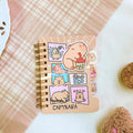 Mini notebook with capybara cartoon cover, gold spiral binding, pastel sticker labels