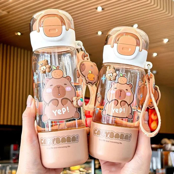 Two clear water bottles with peach flip lids, capybara cartoons, and crossbody rings