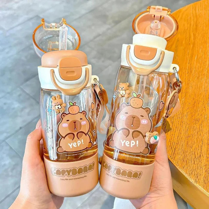 Two capybara-themed clear bottles with peach bases, flip lids, and lanyard handles