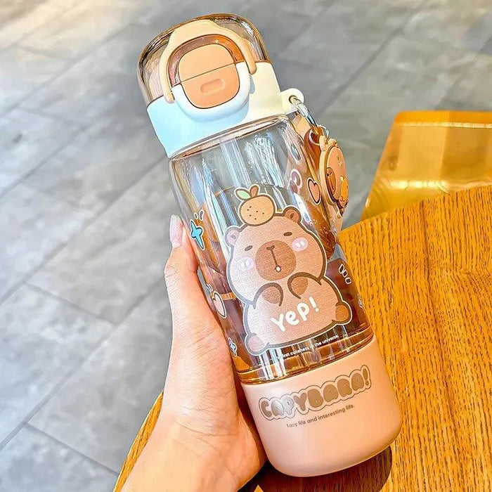 Clear water bottle with peach base, capybara print, and “Yep!” text, held upright