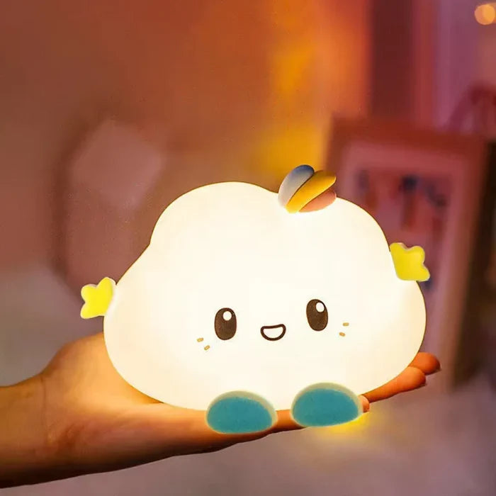 Handheld cloud-shaped LED night light with smiling face, rainbow horn, and blue feet.