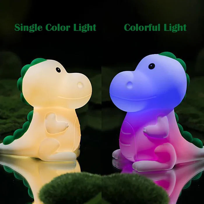 Dinosaur night light with warm white glow on left and blue/purple glow on right, green tail