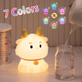 Cute dragon night light with rounded face, small hands, and warm LED glow