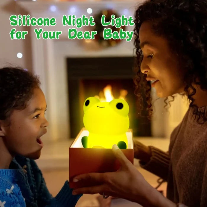 Silicone frog night light glowing yellow inside a box