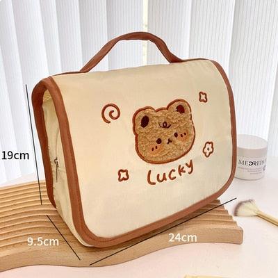 Cute makeup bag with flap, cream fabric and bear face applique with “Lucky”
