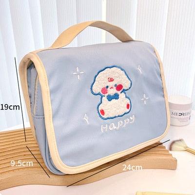 Cute makeup bag with flap, light blue fabric, cloud-and-bear applique with “Happy”