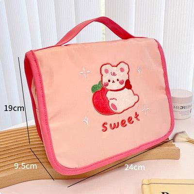 Cute makeup bag with flap, pink-red fabric, bear holding heart applique with “Sweet”
