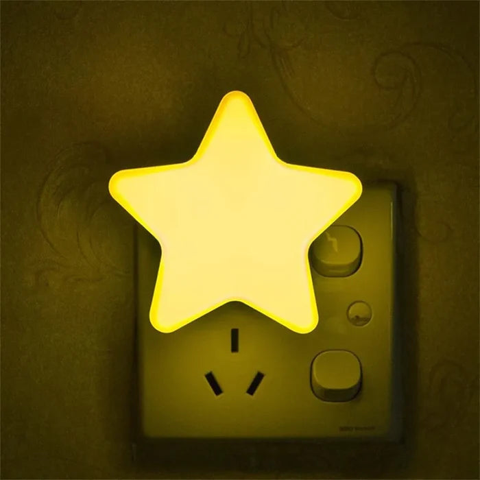 Star plug-in night light with warm yellow glowing star on a wall outlet