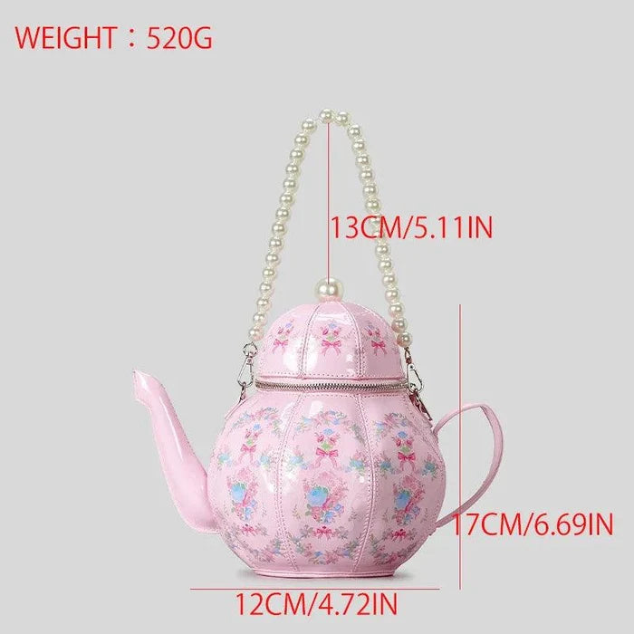 Pink teapot-shaped tea party bag with floral print and pearl-look chain handle