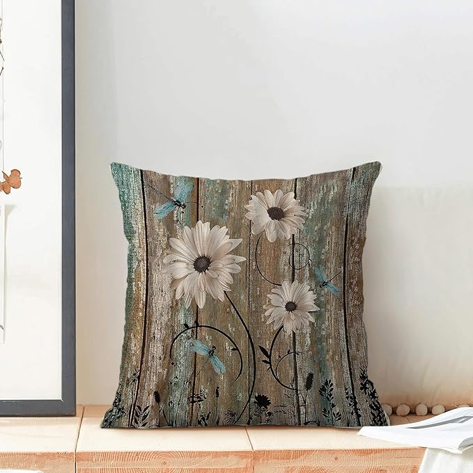 Floral square pillow cover with rustic wood-plank background, daisy blooms and dragonfly accents