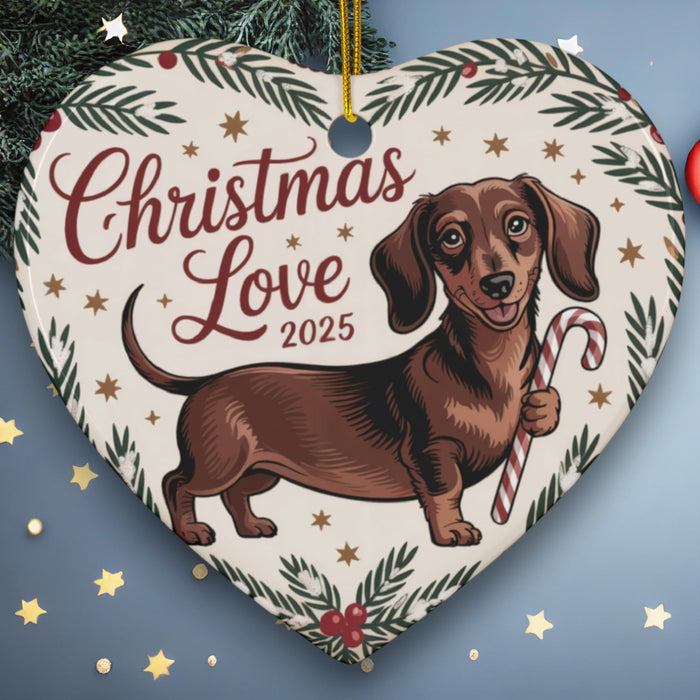 Heart-shaped ceramic ornament with dachshund and text “Christmas Love 2025”.
