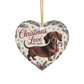 Heart-shaped ceramic ornament with dachshund and “Christmas Love 2025” on a hanging string.