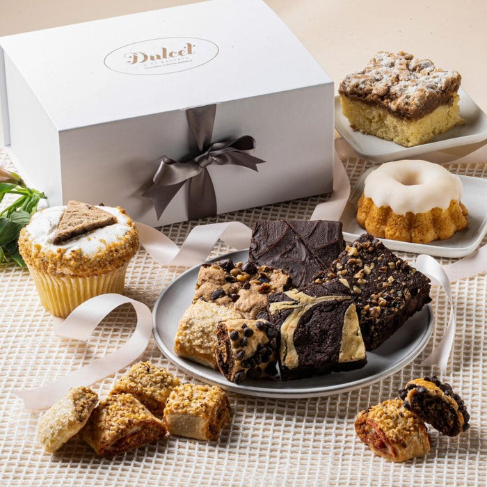 Gourmet pastry gift box with assorted baked treats and a satin ribbon bow