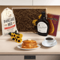 Breakfast gift crate with pancake mix bag, maple syrup bottle, coffee box, flowers