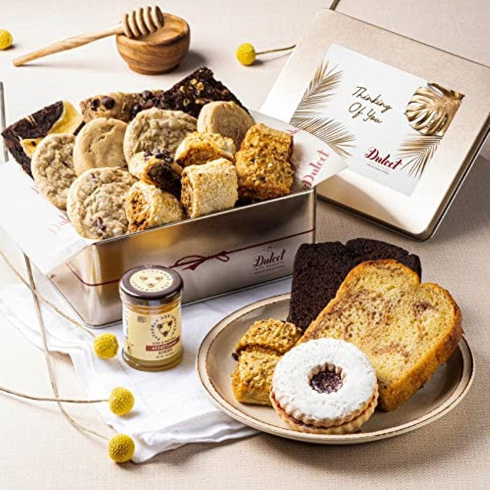 Deluxe honey and pastry gift tin with mixed cookies and a slice of sponge cake