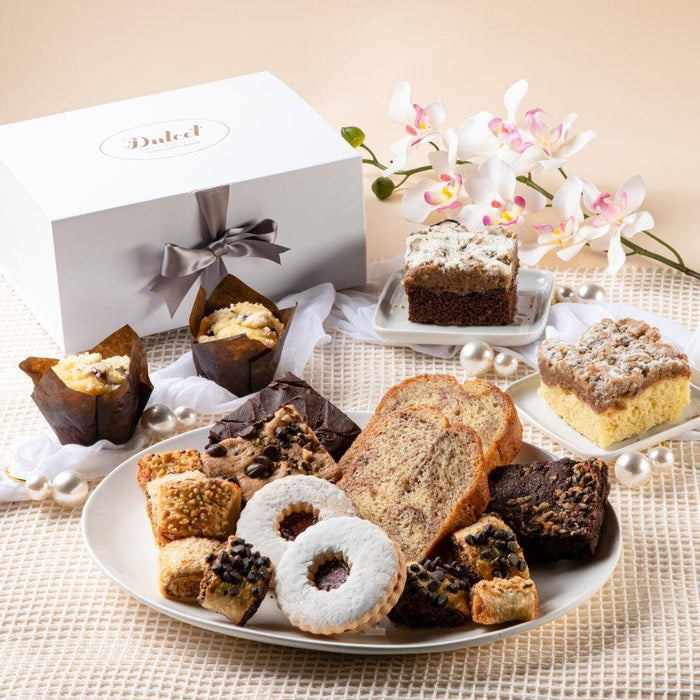 Sympathy pastry gift basket with assorted cookies and cakes on a round tray