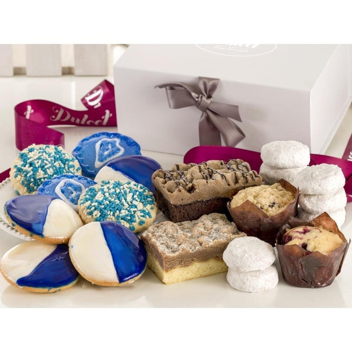 White gift box with ribbon, filled with assorted cookies and pastries