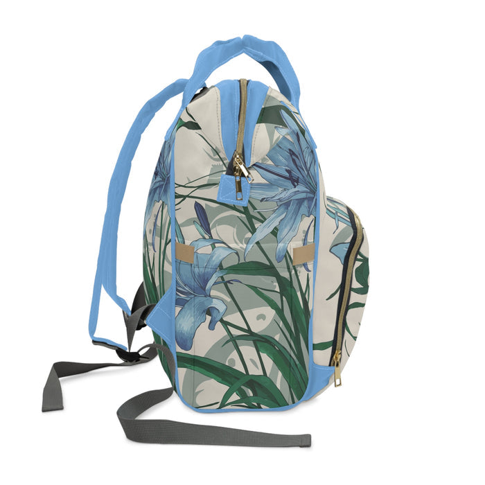 Diaper backpack with blue floral print, adjustable shoulder straps and front zip pouch
