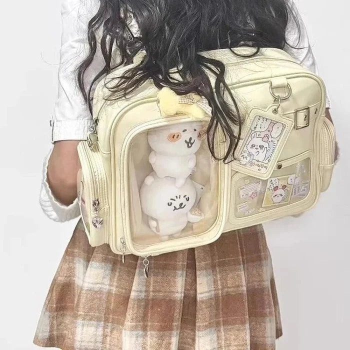 Cream pastel crossbody bag with front clear window pocket and plush charm inside