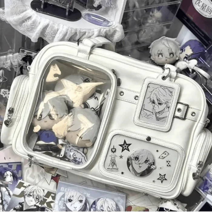 White pastel crossbody bag with clear window compartments and front character card charms