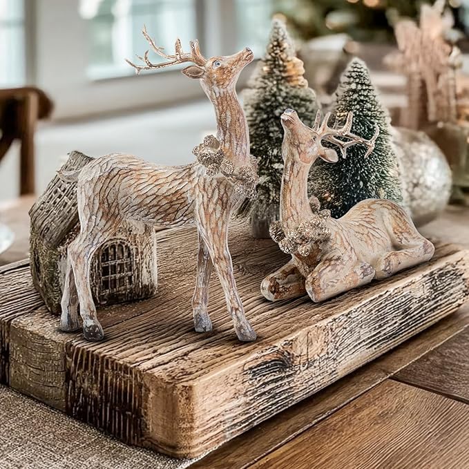 Two brown reindeer resin figurines on a rustic wooden tray, standing and lying