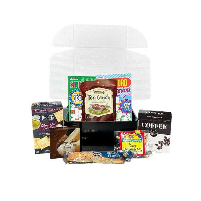 Care package box with tissue, crackers, coffee, tea, candy, and puzzle snacks