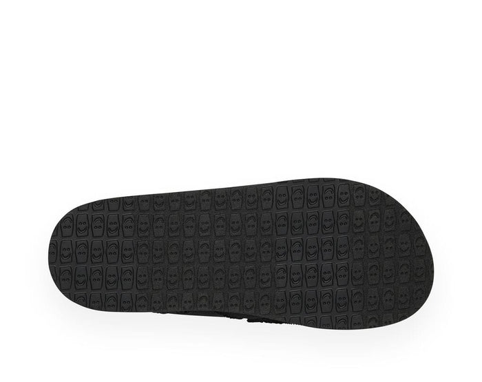Sanuk Vagabond shoe outsole in black with textured smiley face pattern, sole/bottom view.