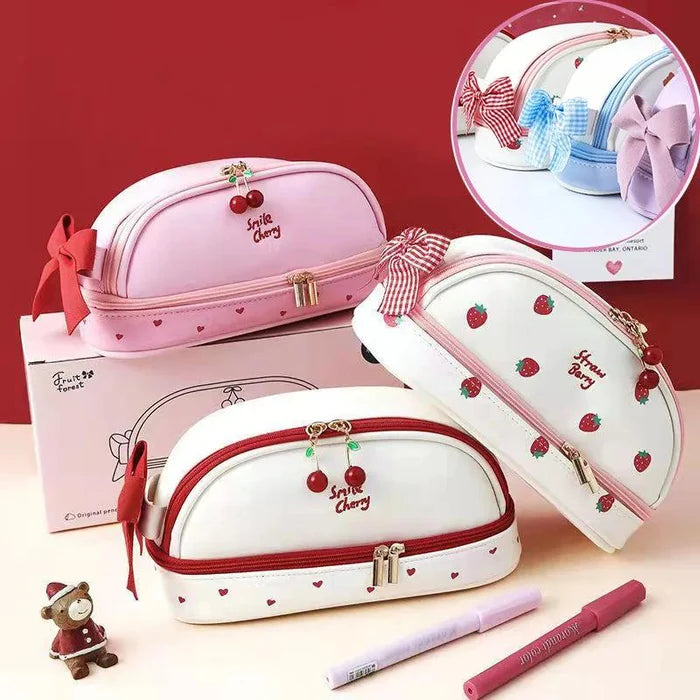 Pink and white double-compartment pencil bag set with strawberry-themed zipper charm.