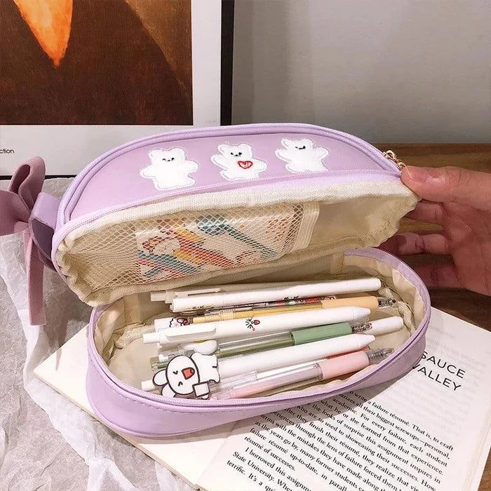 Lavender double-compartment pencil bag open to show mesh pocket and pencils inside.
