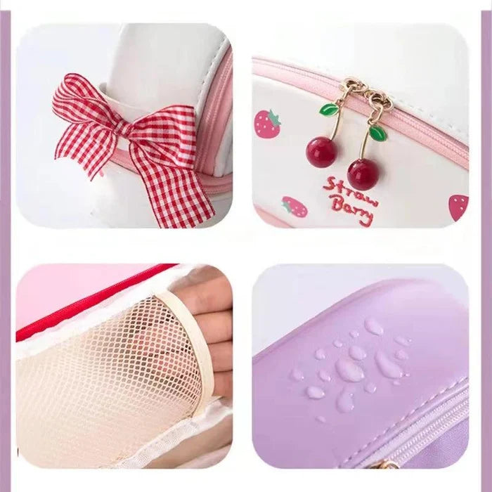 Pink double-compartment pencil bag with bow ribbon and cherry-themed zipper charm.
