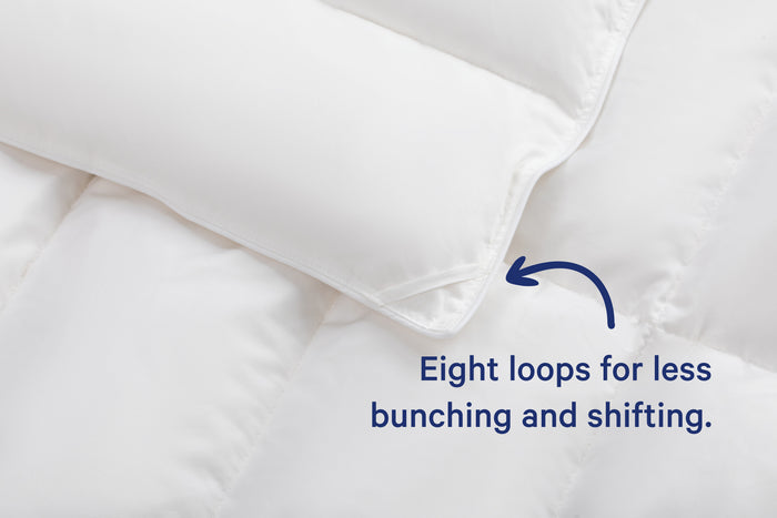 Close-up of the corner of the Down Alt Duvet. Text on the image says "Eight loops for less bunching and shifting."