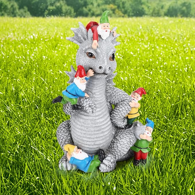Light gray dragon gnome garden statue on green grass with gnomes around its base