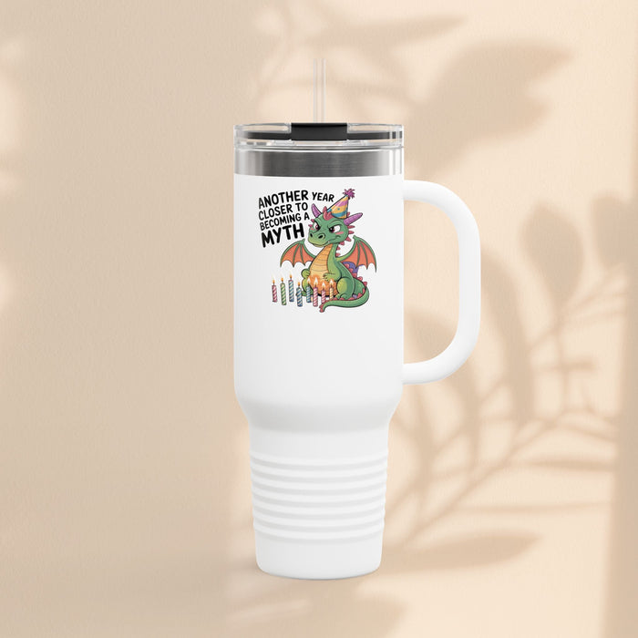 Insulated travel mug with white body, dragon graphic, and clear lid