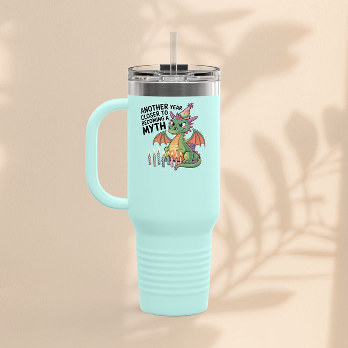 Insulated travel mug with light mint body, dragon graphic, and clear lid