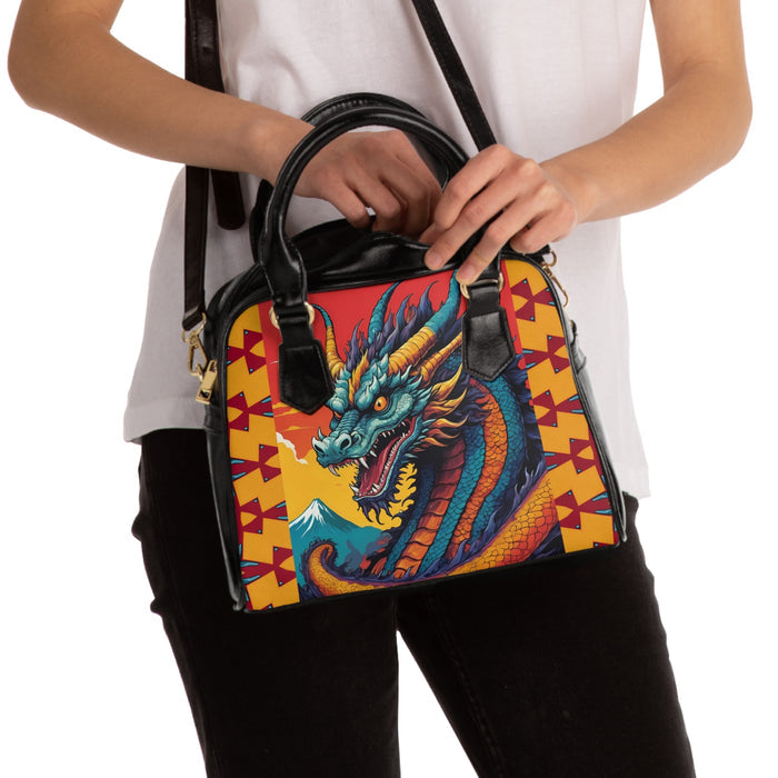 Dragon graphic shoulder handbag with black handles and yellow geometric sides