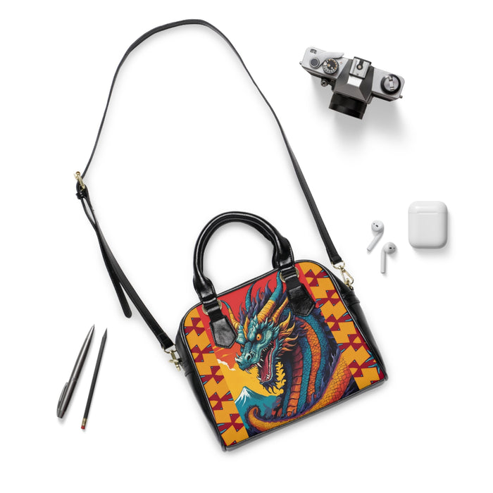 Dragon graphic handbag with long shoulder strap, black hardware, yellow geometric pattern
