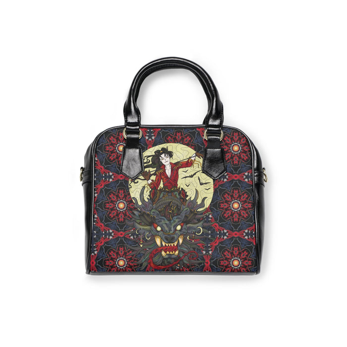 Black top-handle shoulder handbag with red patterned panel and gold-tone accents