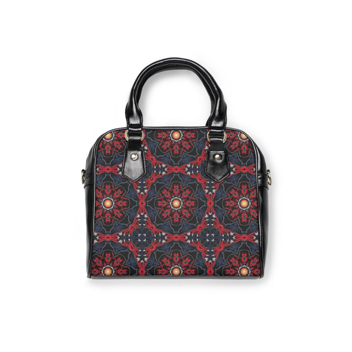 Black top-handle handbag with red repeating pattern and decorative metal studs
