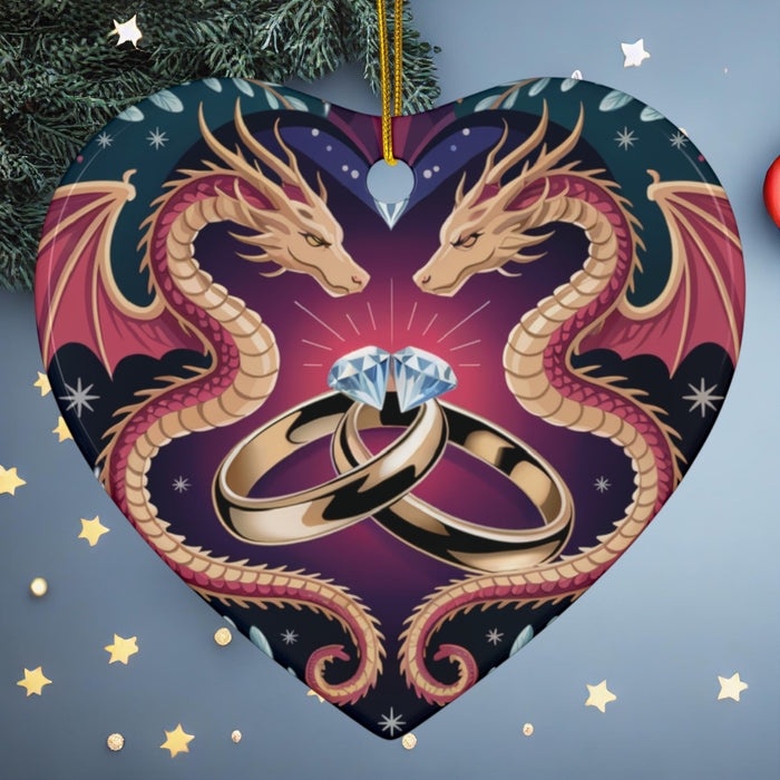 Heart-shaped ceramic ornament with two dragon heads and wedding rings, hanging loop