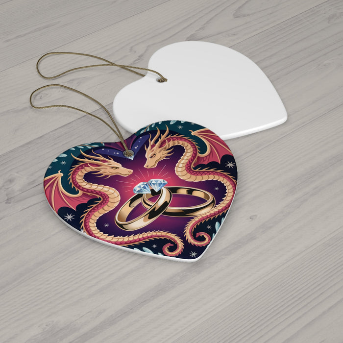 Heart-shaped ceramic ornament with dragon heads and wedding rings, shown on tabletop