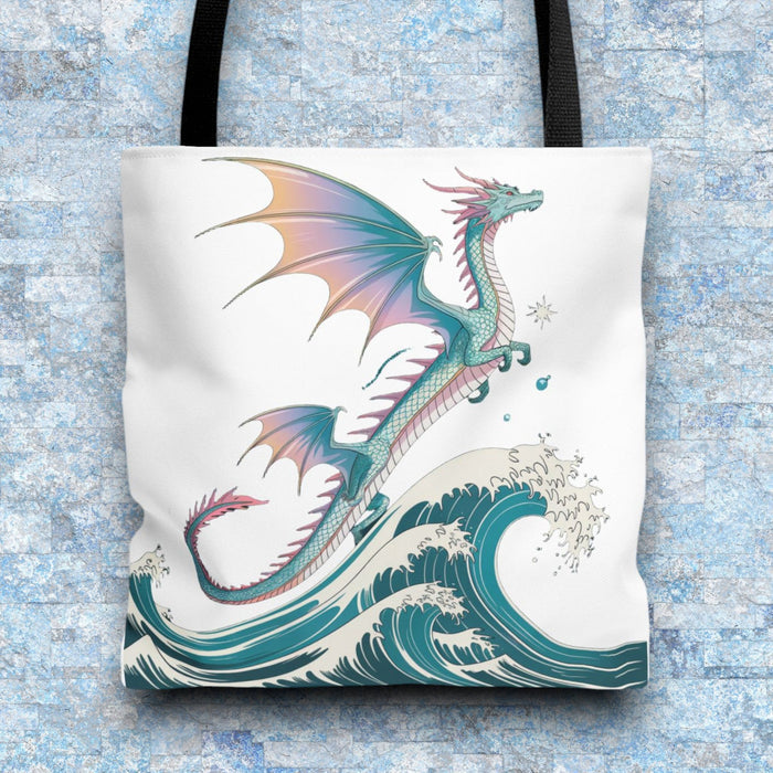 White tote bag with dragon and teal waves graphic, black webbing handles