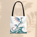 White tote bag with dragon and teal waves print, black handles