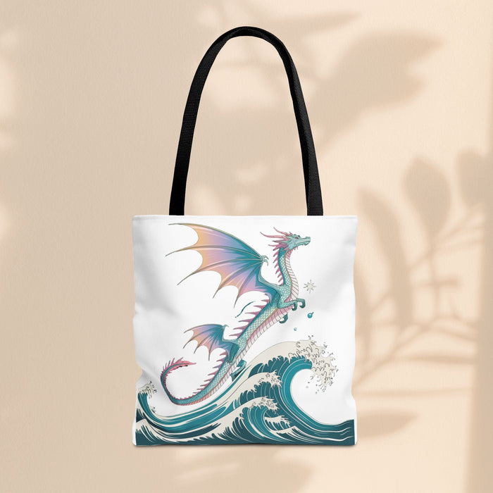 White tote bag featuring teal waves and dragon illustration, black carry handles