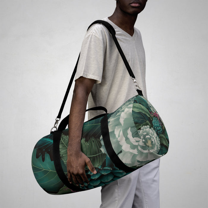 Botanical print duffel bag with black shoulder strap and top zip closure