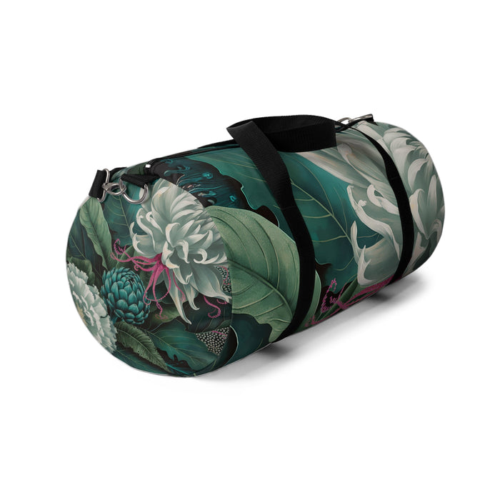 Green botanical duffel bag with black handles, end pocket, and metal hardware
